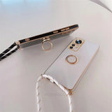 a white phone with a gold ring on it