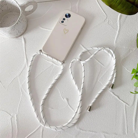 A white phone with a white string on it