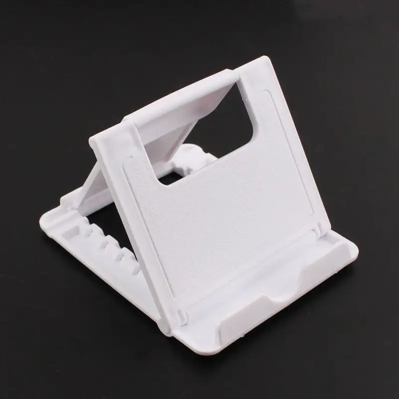 a white plastic phone holder on a black background