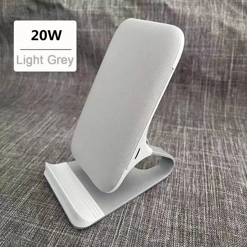 the white phone stand is on a gray couch