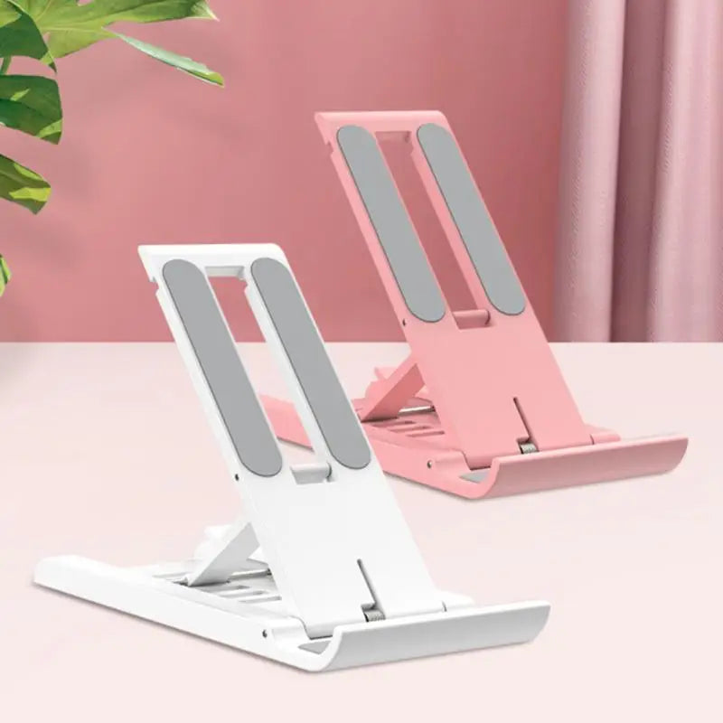 a white and pink phone stand on a table