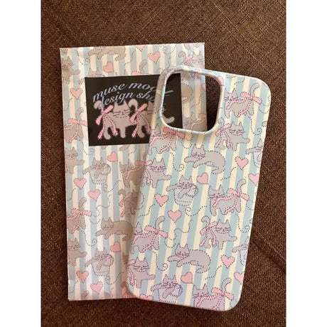 A white and pink unicorn print biard with a black tag