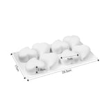 a white plastic tray with four white plastic balls