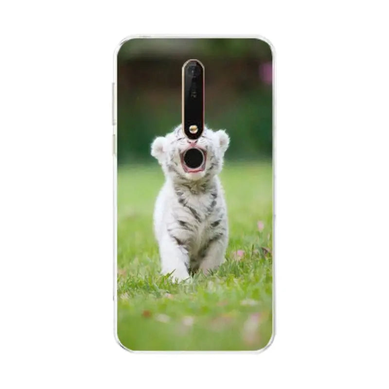 a white dog with a black nose on the grass phone case