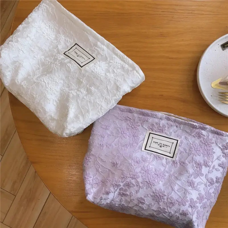 a white and purple bag sitting on top of a wooden table