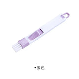 a white plastic clip with a purple handle