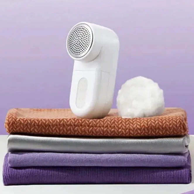 a white and purple towel sitting on top of a white table