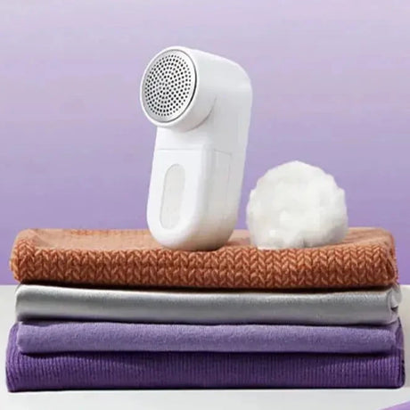 A white and purple towel sitting on top of a white table