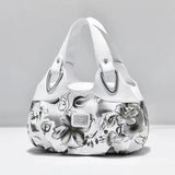 a white purse with a floral pattern