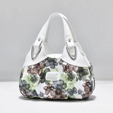 a white purse with a floral print