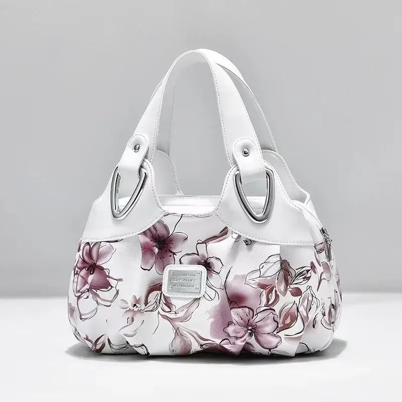 a white purse with pink flowers on it
