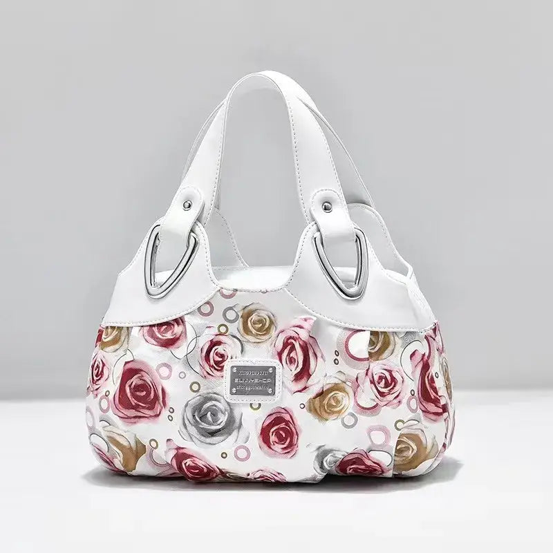 a white purse with pink roses on it