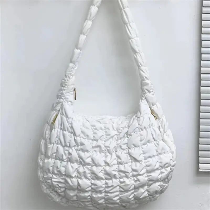 a white purse hanging on a wall