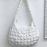 a white purse hanging on a wall