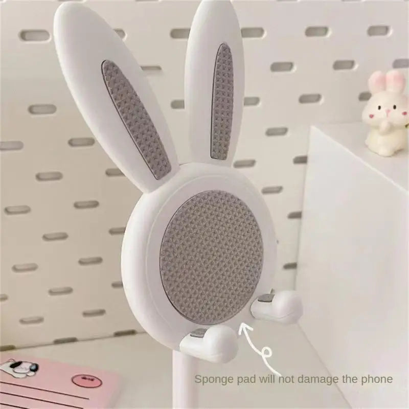 a white rabbit shaped speaker with a white background