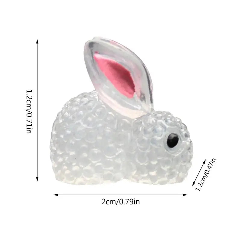 a white rabbit shaped glass fig with a pink nose