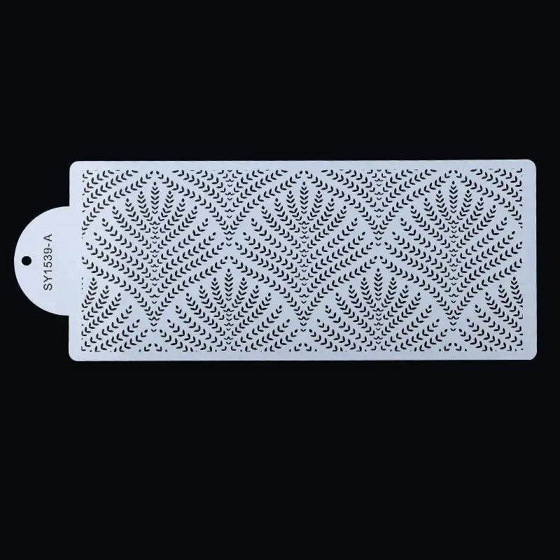 a white rectangular shower mat with a pattern of leaves