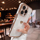 White and rose gold iPhone case with a heart cutout.