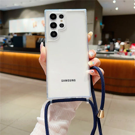 White Samsung smartphone in a clear case with a blue lanyard.