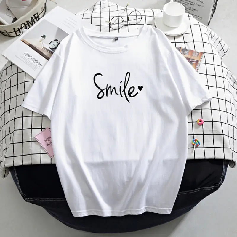 a white shirt with the word smile on it
