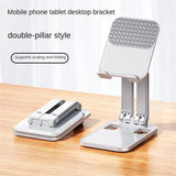 a white and silver phone stand on a wooden table