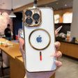 White smartphone in a clear case with gold accents and a visible Apple logo.