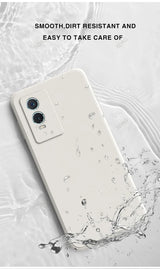 White smartphone with dual cameras being splashed with water.