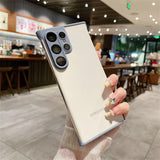 White smartphone with a light purple camera module and trim, held by a hand with decorated nails.