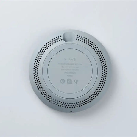 a white wall mounted speaker with a black speaker