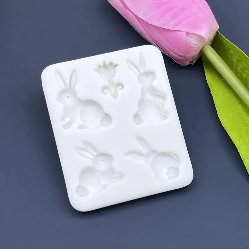 a white soap with a pink flower on it