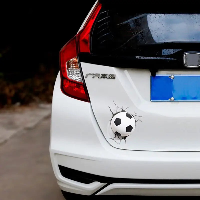 a white car with a soccer ball on the back