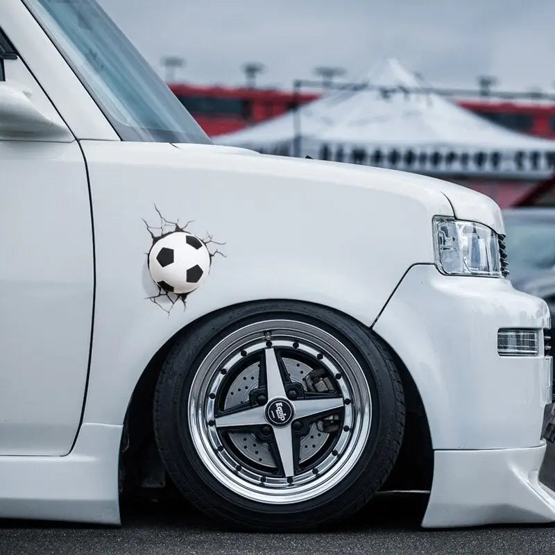 a white car with a soccer ball on the front