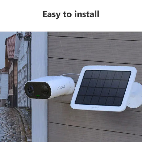 A white solar powered security camera on a wall