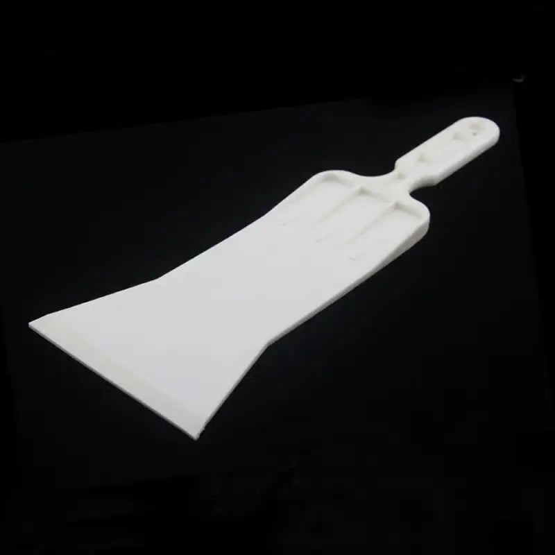 a white plastic spat on a black surface