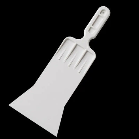 a white spat with a plastic handle
