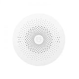 the white speaker with black dots on it
