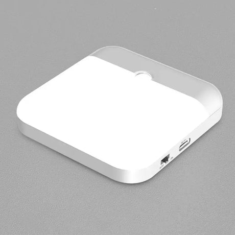 A white square shaped device with a white cover