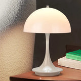 a white table lamp on a wooden table