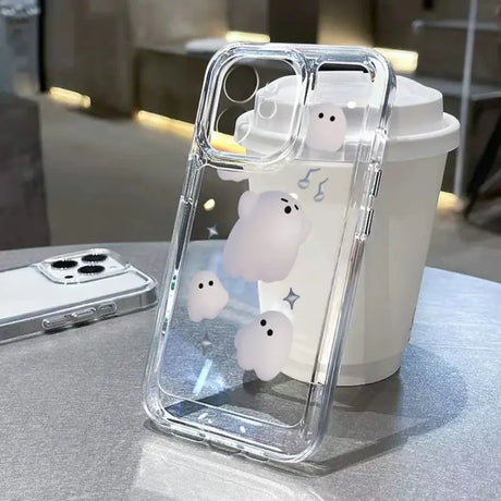 A white teddy bear phone case sitting on a table