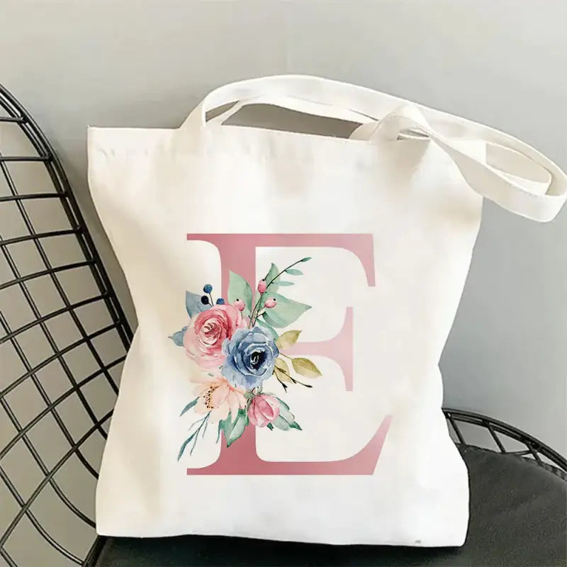 a white tote bag with a floral mono mono