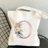 a white tote bag with a floral mono mono