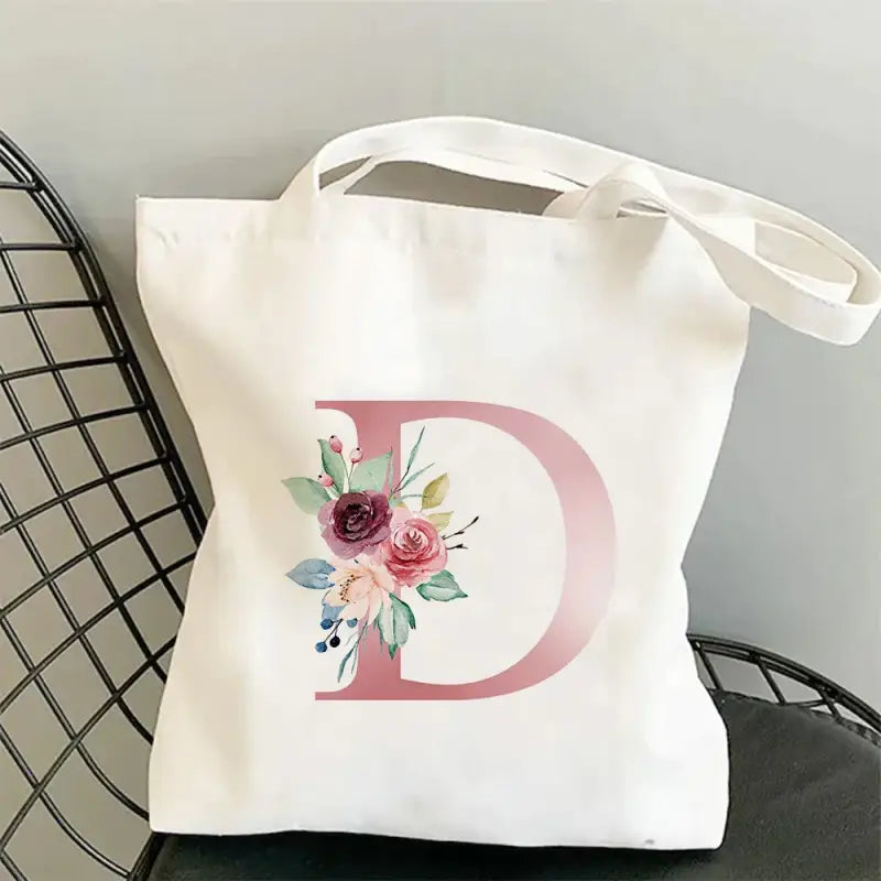 a white tote bag with a floral mono