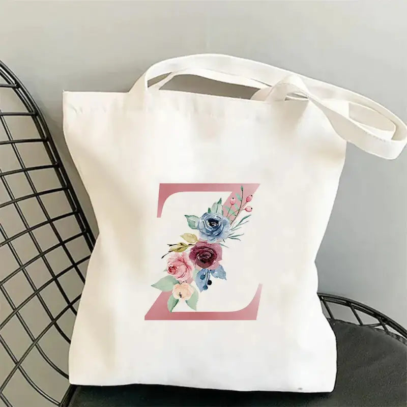 a white tote bag with a floral design