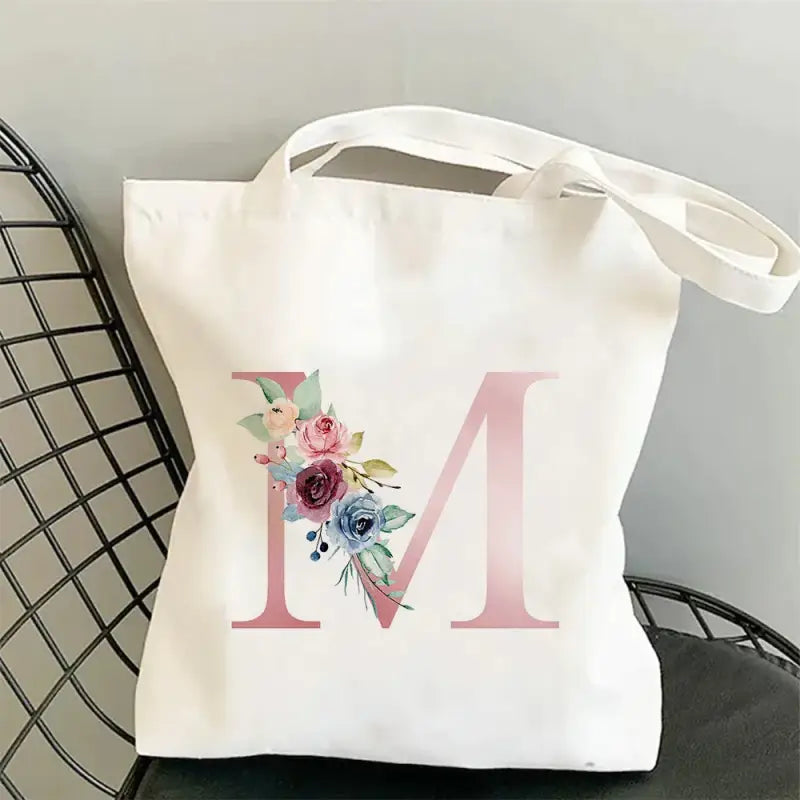 a white tote bag with a floral mono