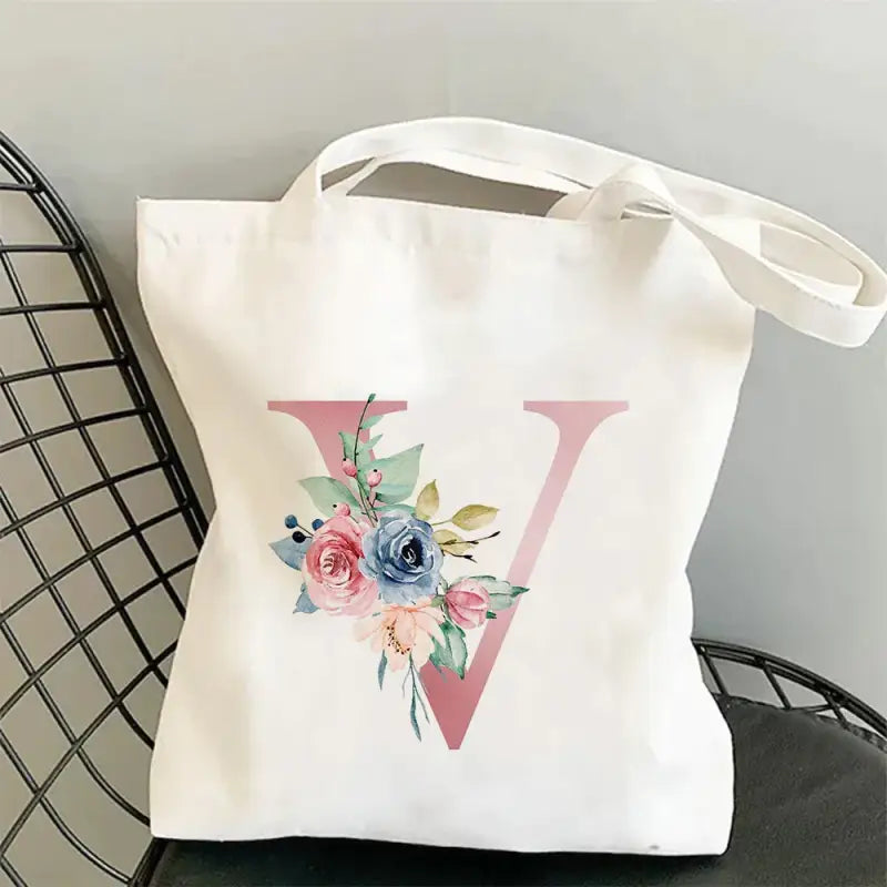 a white tote bag with a floral design