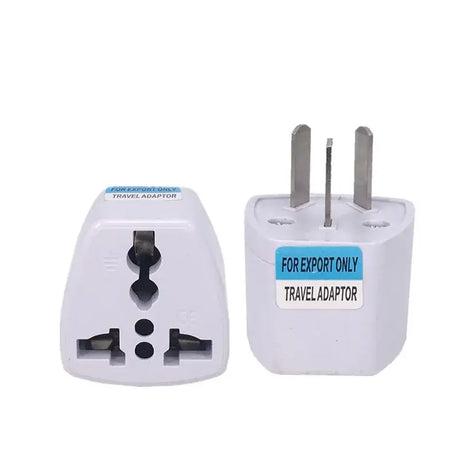 A white travel adapt plug with a blue label