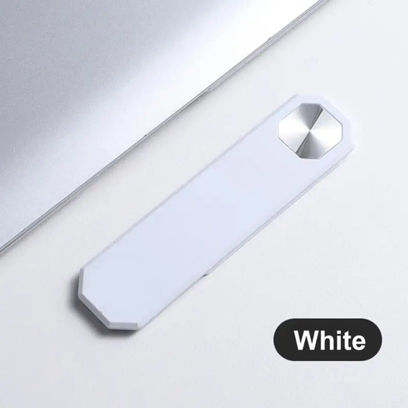 there is a white usb drive next to a laptop computer