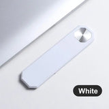there is a white usb drive next to a laptop computer