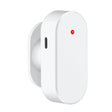 A white wall mounted device with a red button on it