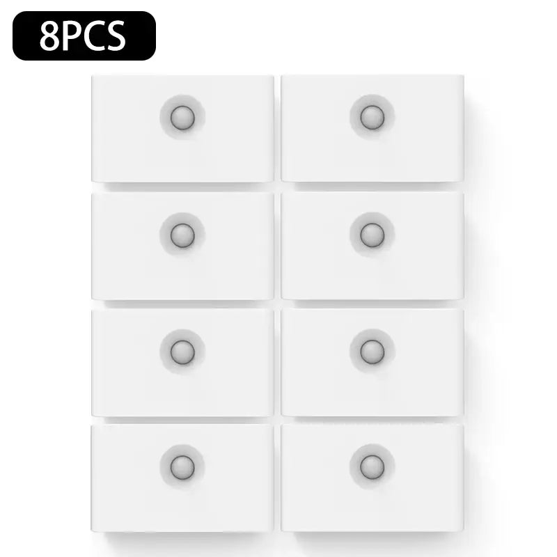 a white wall mounted light switch with six white switches